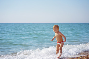 toddler boy on the beach