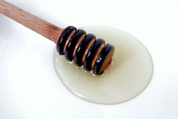 honey dripping from a stick