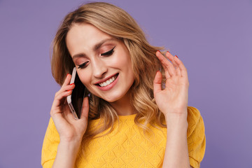 Image of joyful pretty woman smiling while talking on cellphone