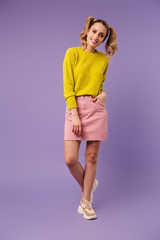 Image of pleased pretty woman with two tails smiling and looking at camera