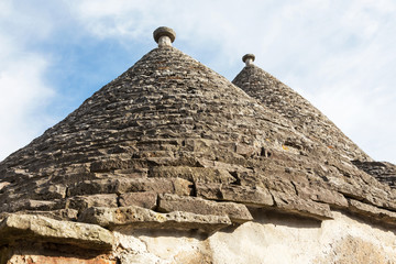 Fototapeta na wymiar Typical conical stone roof of a house - trullo in Alberobello, Puglia, Italy