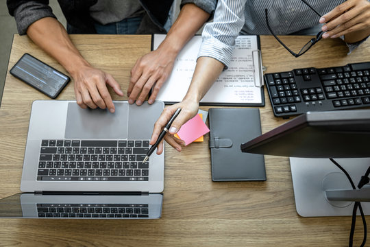 Two professional programmer cooperating and working on web site project in a software developing on desktop computer at company, codes and typing data code, Programming with HTML, PHP and javascript