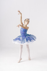 Fototapeta na wymiar Beautiful preteen girl ballerina wearing a princess dress, winter fairy dancing over white background