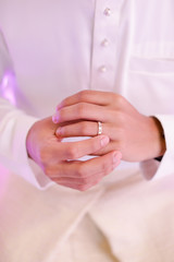a groom putting his ring on