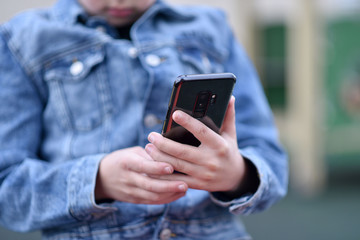 Closeup of Teenager holding a phone in his hand