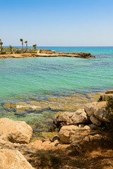 Mediterranean coast with a rocky coast and turquoise sea and people