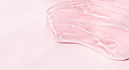 Cosmetic clear liquid transparent cream. Skin care product on pink background.  Copy space.