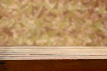 wooden background with green leaves