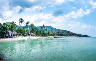  People swim and sunbathe on Haad yao beach, Koh Phangan.