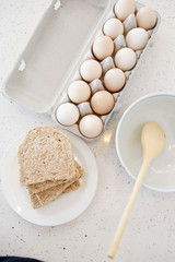 a rack of chicken egg and a plate of bread use to make a healthy breakfast