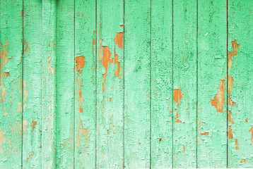 Old vintage green rustic wooden boards with cracked and peeling paint texture background.