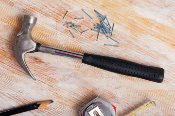 Hammer and nails on wooden background