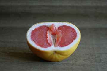 Vagina, clitoris and labia symbol. Grapefruit looks like a vagina (vulva), with the clitoris and...
