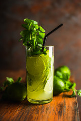 Mojito cocktail with lime and mint on the rustic background. Selective focus. Shallow depth of field.
