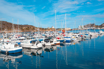 Fototapeta na wymiar Port for small vessels. Berth with yachts, boats, sailboats, boats.