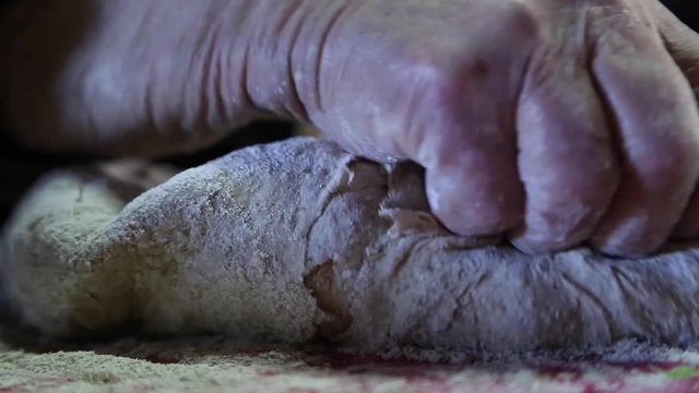 Woman kneading to make bread.