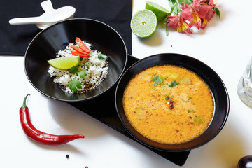 Tom Kha. Spicy spicy Asian soup with eggplant, chicken, mushrooms, lemongrass, served with rice and cilantro