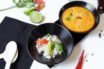 Tom Kha. Spicy spicy Asian soup with eggplant, chicken, mushrooms, lemongrass, served with rice and cilantro