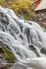 Fototapeta premium A waterfall in a forest in central Sweden photographed by a long exposure.