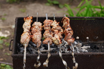 Barbecue meat on skewers, beautifully browned meat on the grill. A pork meat on the grill in the...