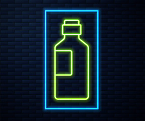 Glowing neon line Bottle of water icon isolated on brick wall background. Soda aqua drink sign. Vector