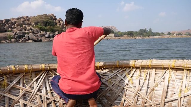 Boatman rowing on the Tungabhadra River in Hampi, Karnataka