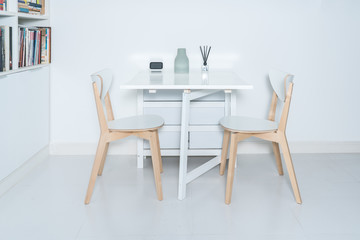 Dining tables and chairs and furnishings in a minimalist modern home. Working at home in a minimalist home.