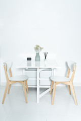 Dining tables and chairs and furnishings in a minimalist modern home.