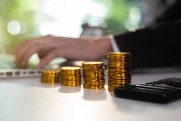 Male Business accountant with calculator save data to Laptop computer financial on office table. concept planning budget and audit. at home office.