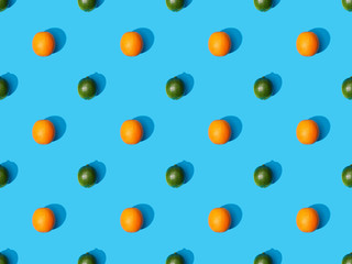 top view of ripe oranges and limes on blue colorful background, seamless pattern