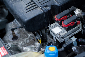 View of the engine compartment of a small car with dirt and dust build-up on the engine technology expert fault diagnosis fault finding alternator technology
