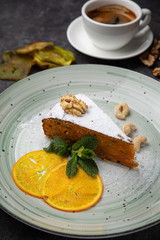 Nut cake with a cup of coffee on a black background