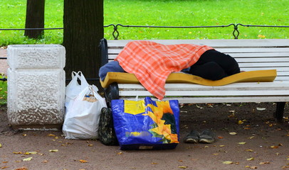 Sleeping on a bench homeless, Aleksandrovskiy garden, Saint-Petersburg, Russia September 2017