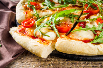 homemade pizza with fresh arugula