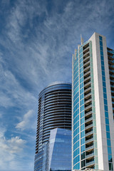 Fototapeta premium Two Modern Blue Glass and Steel Towers on Blue Sky