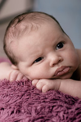 Adorable newborn sleeping inside a wicker basket