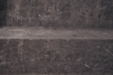 Close up of staircase on black stone wall corner background. Black lobby interior rough concrete...