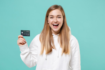 Laughing young woman girl in casual white hoodie posing isolated on blue turquoise background...