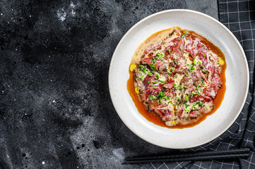 tataki beef with fresh green onions. black background. Top view. Copy space
