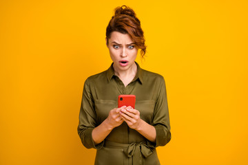 Portrait of her she nice attractive lovely outraged worried wavy-haired girl using device browsing reading fake news isolated on bright vivid shine vibrant yellow color background