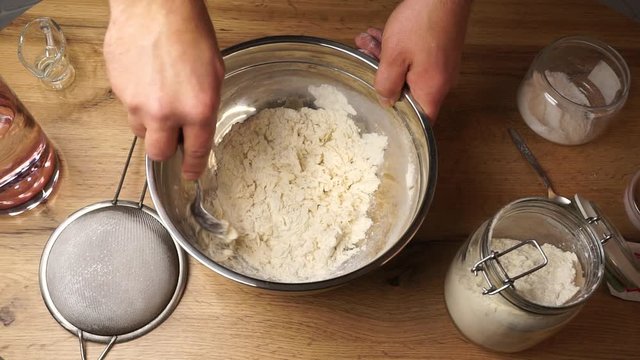 Fast motion footage of full process of mixing flour with ingredients and kneading a nice dough for bakery
