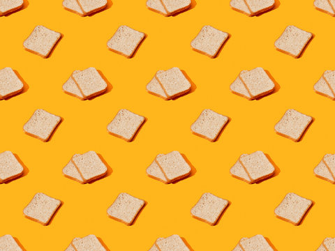 fresh toast bread on orange colorful background, seamless pattern