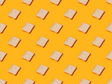 fresh toast bread on orange colorful background, seamless pattern