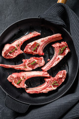 Rack of lamb , raw meat with bone. Organic lamb meat. Black background. Top view