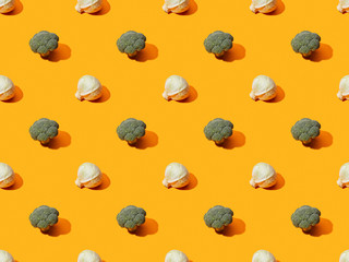 fresh green broccoli and cabbage on orange background, seamless pattern