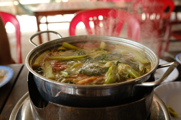 Close up shot of the pot of boiling soup on a restaurant table in Vietnam. Hot Pot.