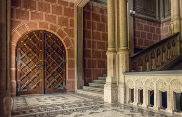 Chernivtsi city, Bukovina, Ukraine - June 12, 2018: ancient wrought-iron door and a marble staircase in the lobby of the old university building in the city of Chernivtsi. Medieval architecture © Maryna Konoplytska