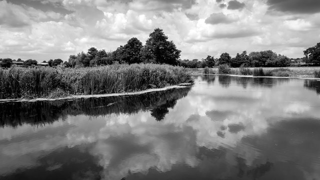 the river stour at fiddleford mill with clouds and reflections in river © SearchingForSatori