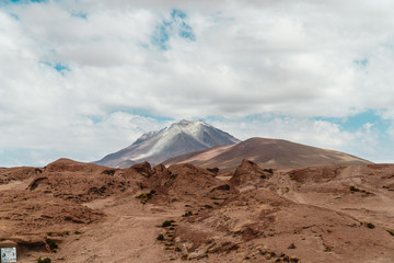 Rocky landscape mountain background. Dry, Barren desert, snowcapped mountains wilderness. Mountain range view. Salt Flats of Uyuni, Bolivia. Copy space, Rocks, blue sky, nature, hiking, sand dust