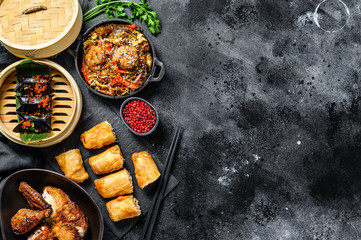 Chinese food. Noodles, dumplings, stir fry chicken, dim sum, spring rolls. Chinese cuisine set.  Black background. Top view. Copy space